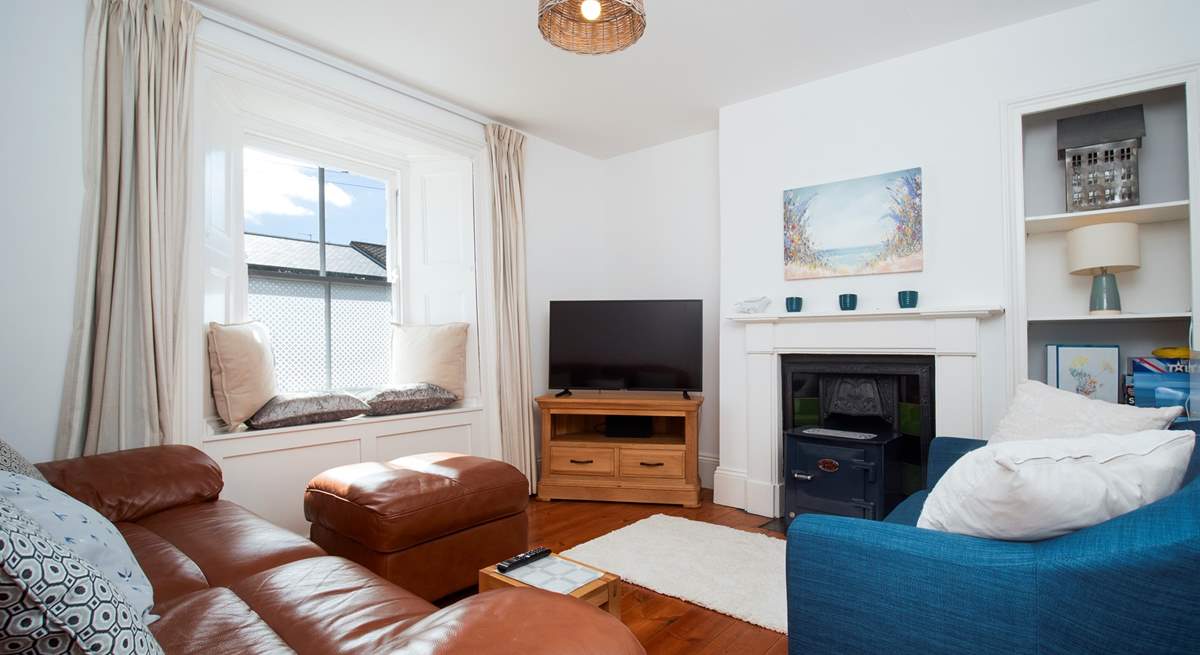 The lovely cosy sitting-room -(the wood burner has been removed and now a decorative fireplace).