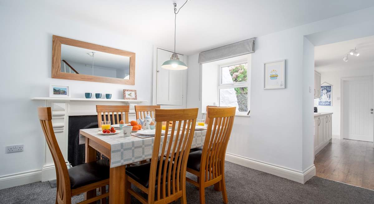 The dining-area is a lovely space to enjoy breakfast together. A small step takes you down into the kitchen area. 