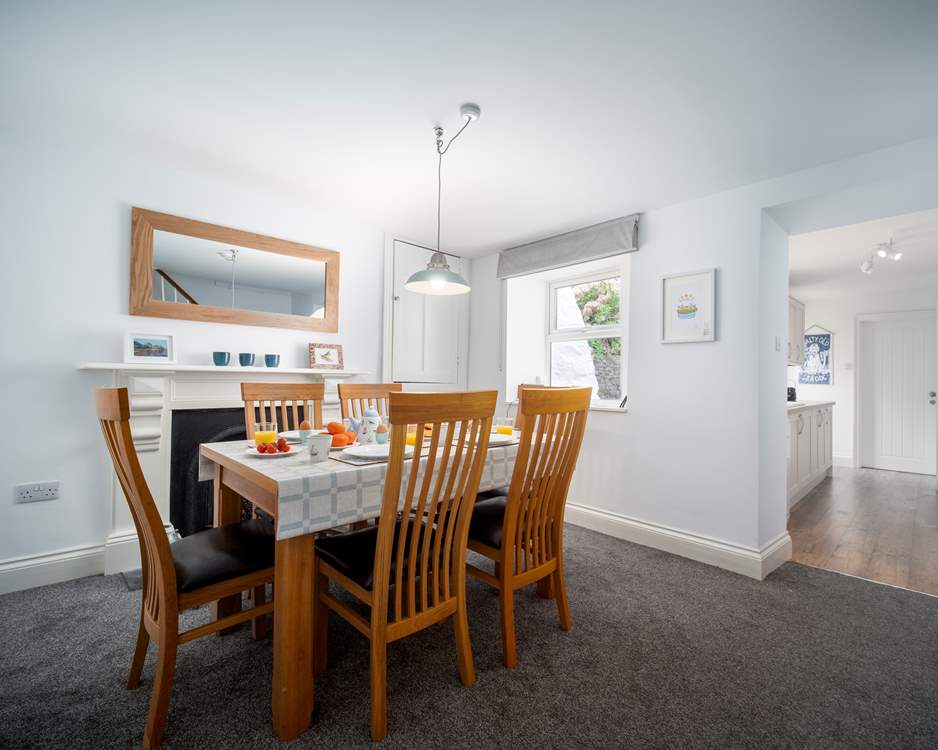 The dining-area is a lovely space to enjoy breakfast together. A small step takes you down into the kitchen area.