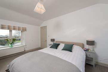This peaceful en suite room can be accessed from the main landing or via a dressing room that links through to the master bedroom. Its views are over the gardens and the valley beyond. A second window looks out into the farmyard.