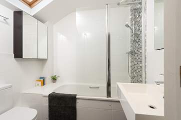 The master bedroom has an en suite bath and fitted shower.