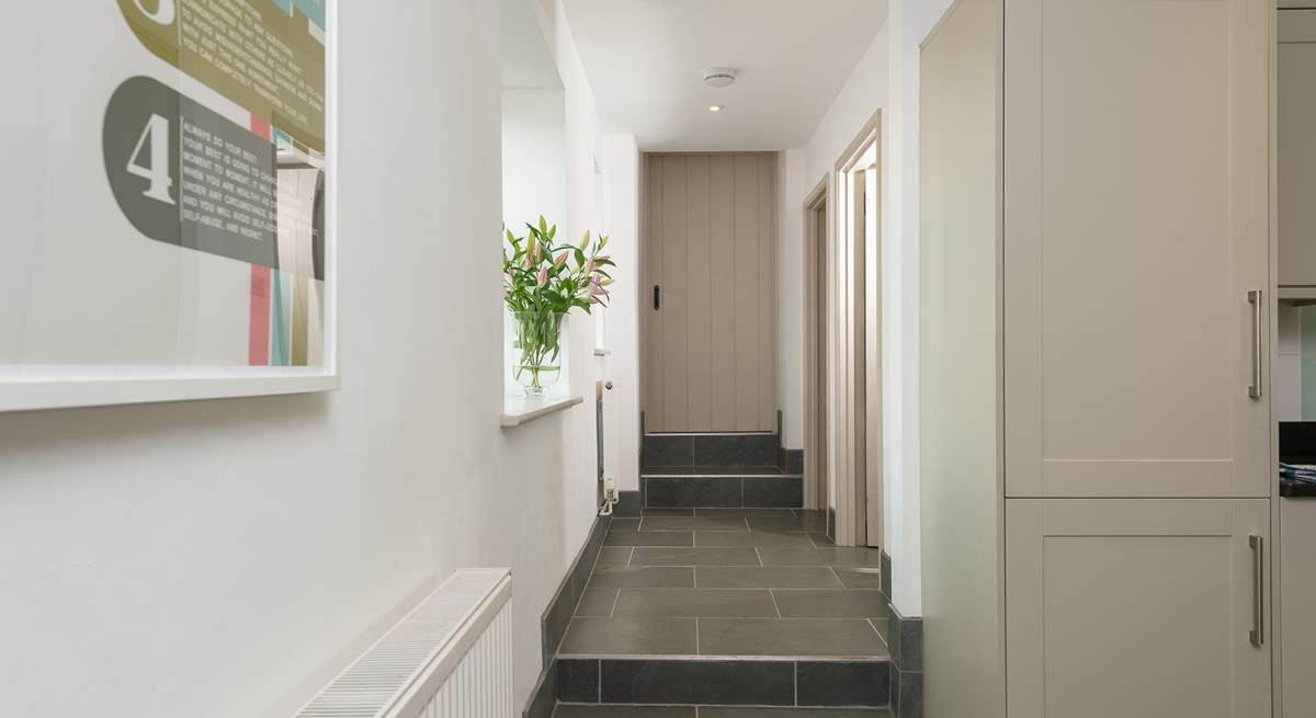 A couple of steps lead up from the kitchen to the utility-room, the second staircase (to the master bedroom) and the door to the 'engine room' of the farmhouse - the bio mass boiler room. Beyond that room is a locked link door to the owners home.