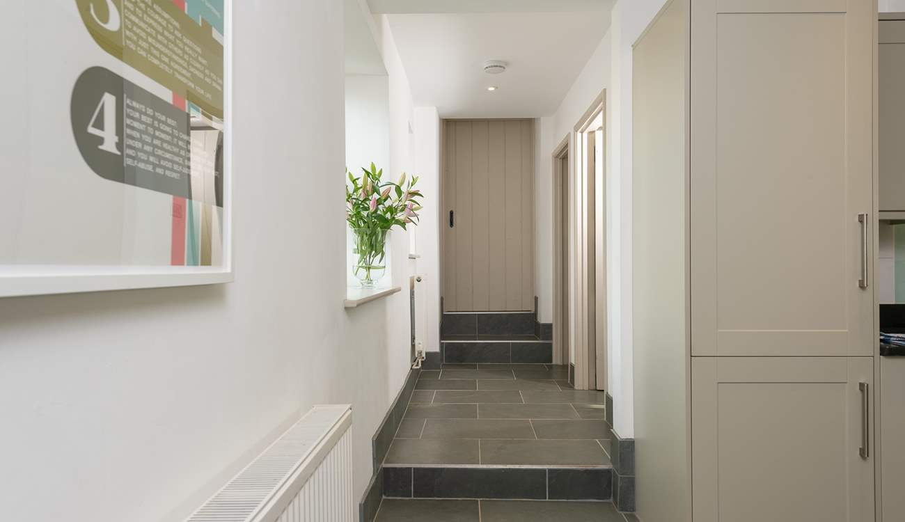 A couple of steps lead up from the kitchen to the utility-room, the second staircase (to the main bedroom) and the door to the 'engine room' of the farmhouse - the bio mass boiler room. Beyond that room is a locked link door to the owners home.