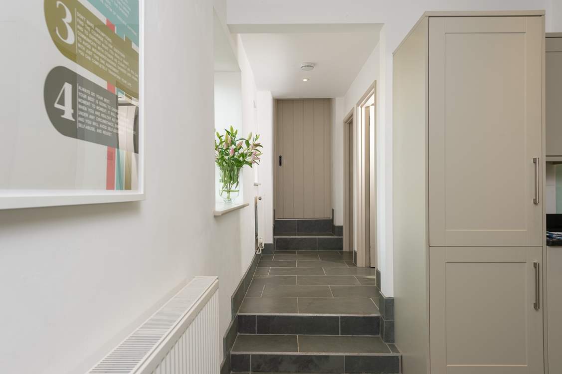 A couple of steps lead up from the kitchen to the utility-room, the second staircase (to the main bedroom) and the door to the 'engine room' of the farmhouse - the bio mass boiler room. Beyond that room is a locked link door to the owners home.