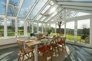 The garden-room links from the spacious kitchen and to the main sitting-room - and of course to the patio and the extensive garden. There are lovely open views to the south.