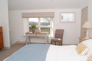 This is the master bedroom. All the rooms are en suite but this bedroom even has its own staircase! This room has dual-aspect windows, with the second window looking over the farmstead.