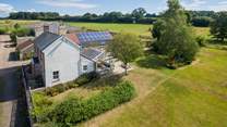 Wreath Farmhouse in its wonderful setting with extensive south-facing gardens and a garden-room.