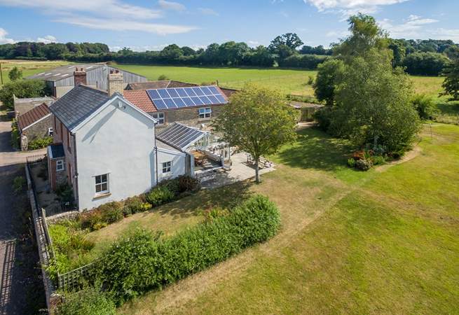 Wreath Farmhouse in its wonderful setting with extensive south-facing gardens and a garden-room.