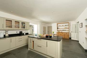 The wonderful farmhouse kitchen with island, breakfast-bar, breakfast-table and flagstone floors.