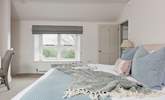 All the rooms are en suite but this bedroom even has its own staircase! This room has dual-aspect windows, with the second window looking over the farmstead. - Thumbnail Image