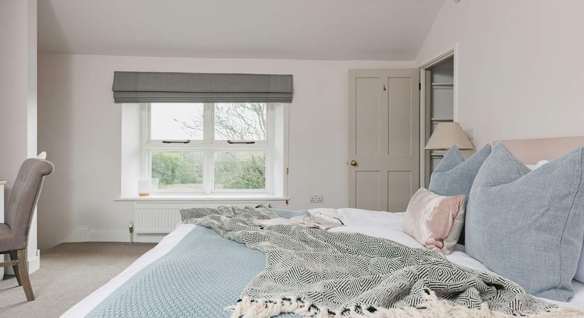 All the rooms are en suite but this bedroom even has its own staircase! This room has dual-aspect windows, with the second window looking over the farmstead.