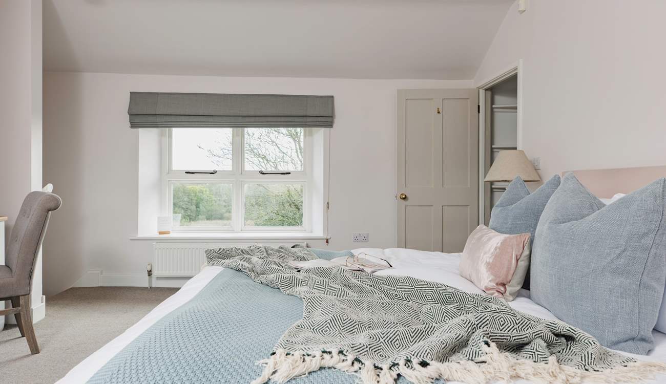 All the rooms are en suite but this bedroom even has its own staircase! This room has dual-aspect windows, with the second window looking over the farmstead.