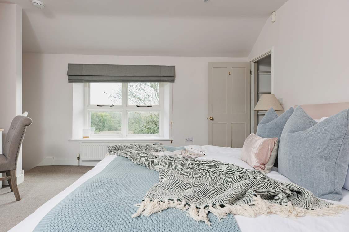All the rooms are en suite but this bedroom even has its own staircase! This room has dual-aspect windows, with the second window looking over the farmstead.