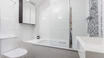 This bedroom has an en suite bath and fitted shower.