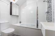 This bedroom has an en suite bath and fitted shower.