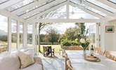 The fabulous garden-room makes a lovely dining-room. The double doors to the right lead into the main sitting-room. - Thumbnail Image