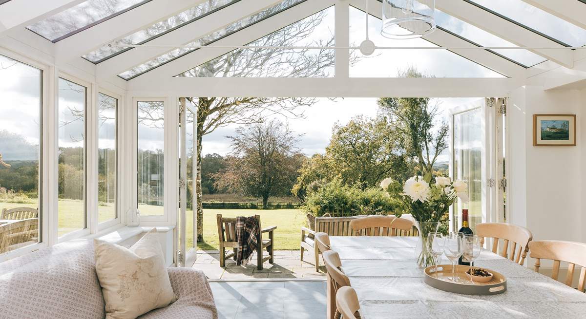 The fabulous garden-room makes a lovely dining-room. The double doors to the right lead into the main sitting-room.