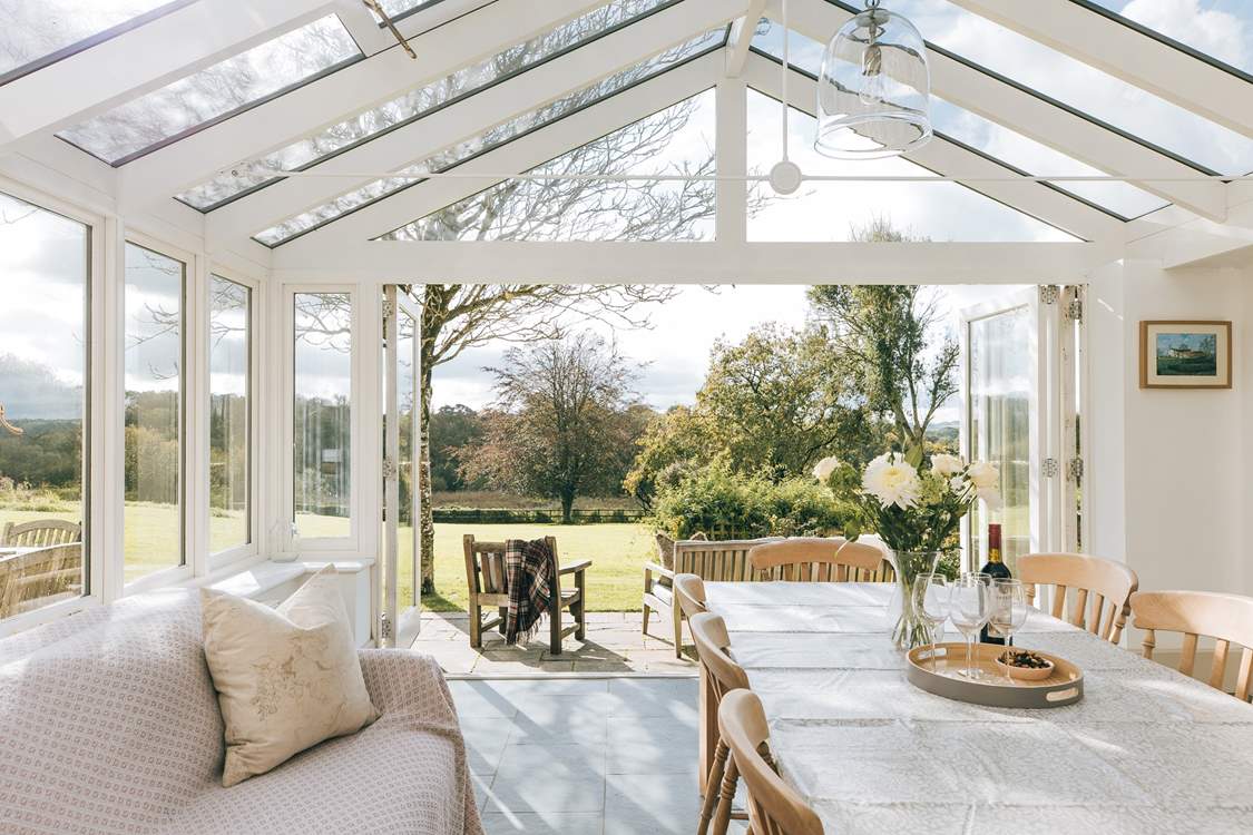 The fabulous garden-room makes a lovely dining-room. The double doors to the right lead into the main sitting-room.