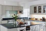 The kitchen has a large island/breakfast-bar as well as the breakfast table.