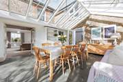The garden-room is an ideal dining space with plenty of light during the day, the stars at night and wonderful country views.