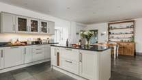 The wonderful farmhouse kitchen with island, breakfast-bar, breakfast-table and flagstone floors.