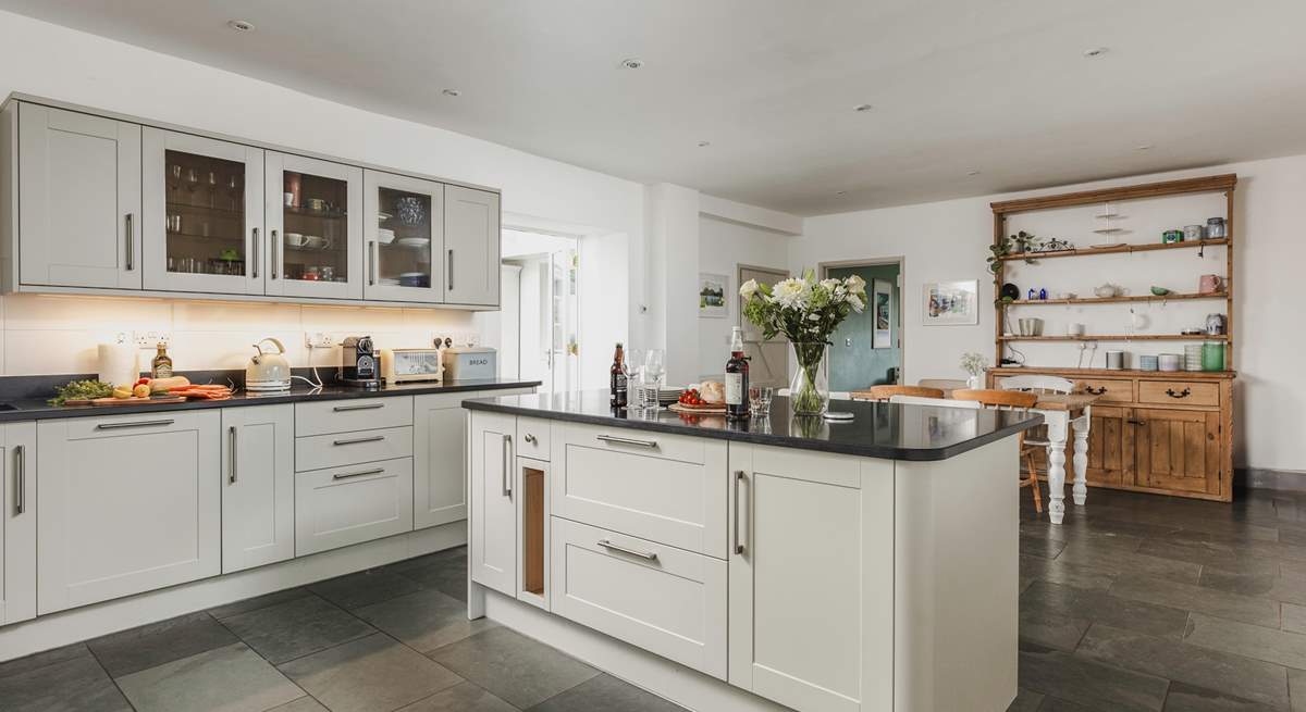 The wonderful farmhouse kitchen with island, breakfast-bar, breakfast-table and flagstone floors.