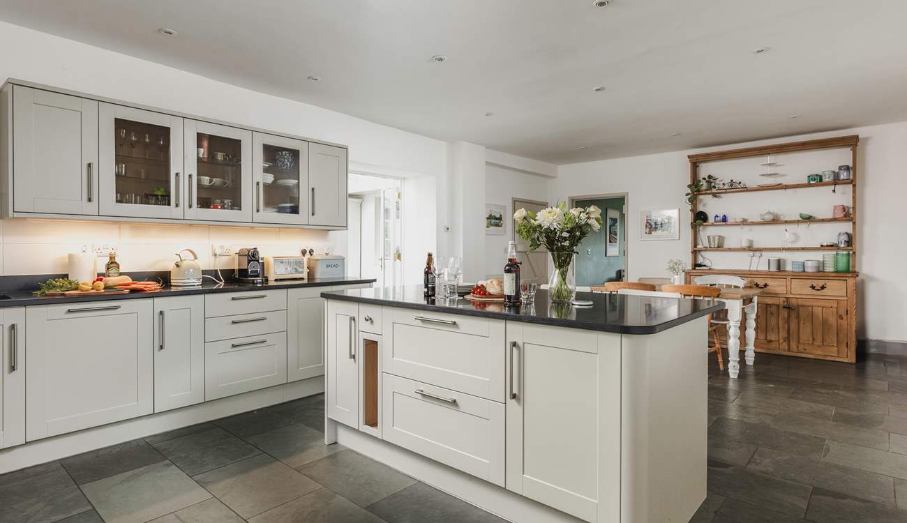 The wonderful farmhouse kitchen with island, breakfast-bar, breakfast-table and flagstone floors.