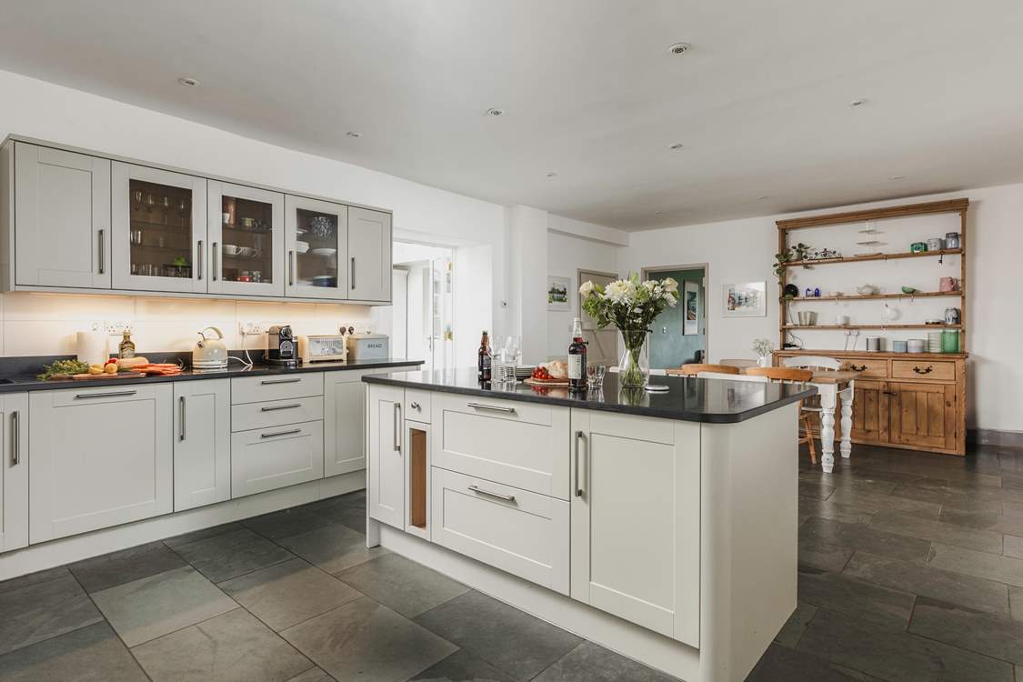 The wonderful farmhouse kitchen with island, breakfast-bar, breakfast-table and flagstone floors.