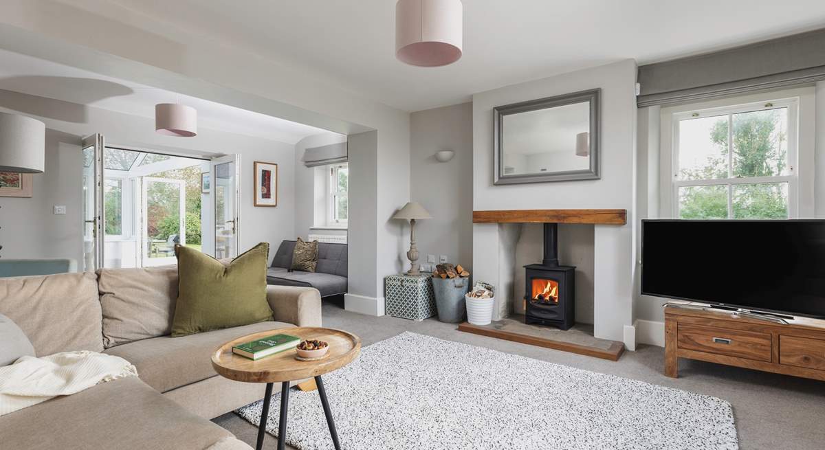 This is the gracious main sitting-room. Double doors lead into the garden-room. 