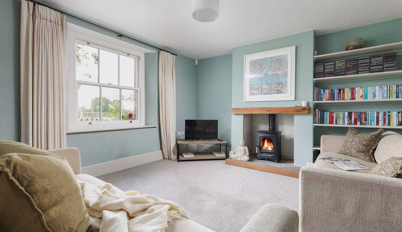 This is the tranquil snug which also has a wood-burning stove. This room links directly to the kitchen and the front hall.