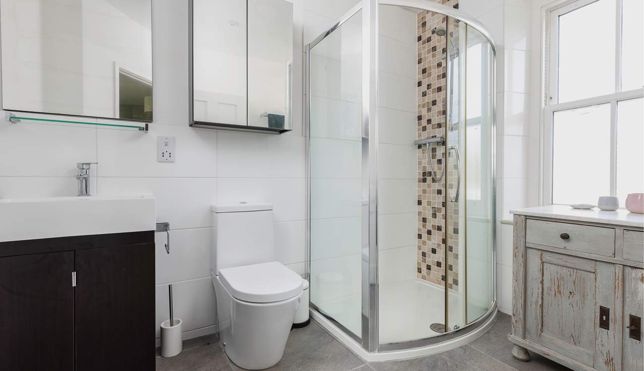 This bedroom has a spacious contemporary shower-room. When the window is open it looks out over the gardens. 