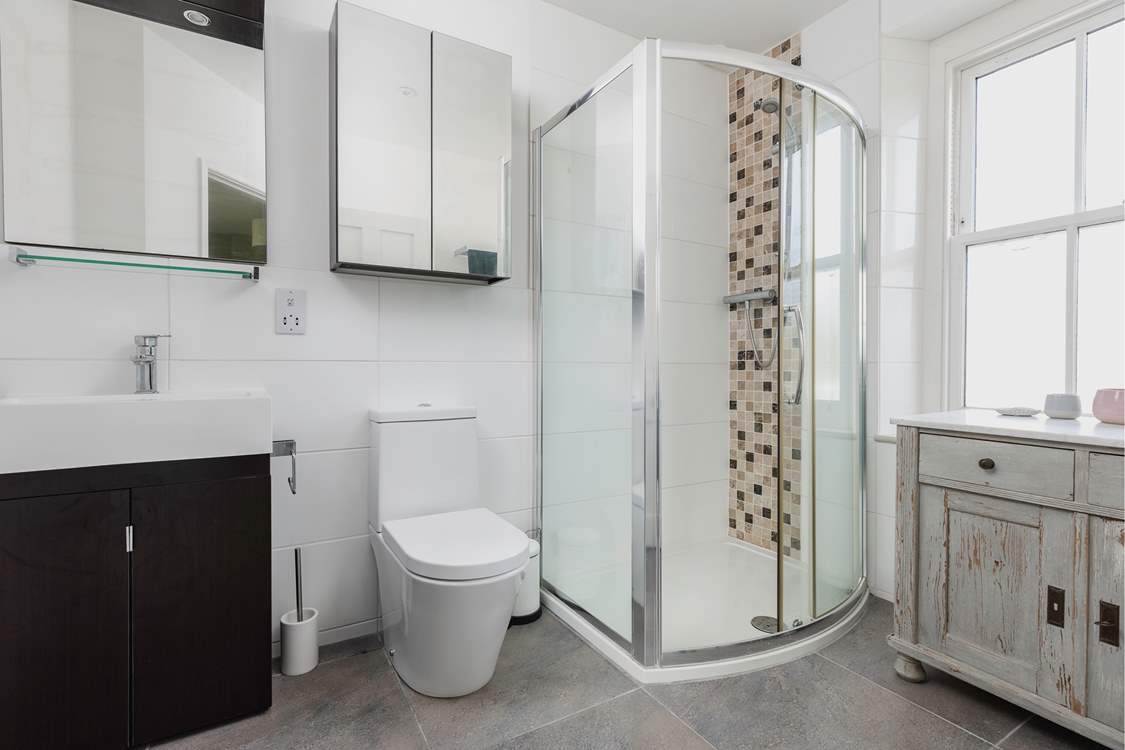 This bedroom has a spacious contemporary shower-room. When the window is open it looks out over the gardens.