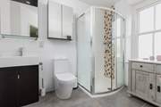 This bedroom has a spacious contemporary shower-room. When the window is open it looks out over the gardens.