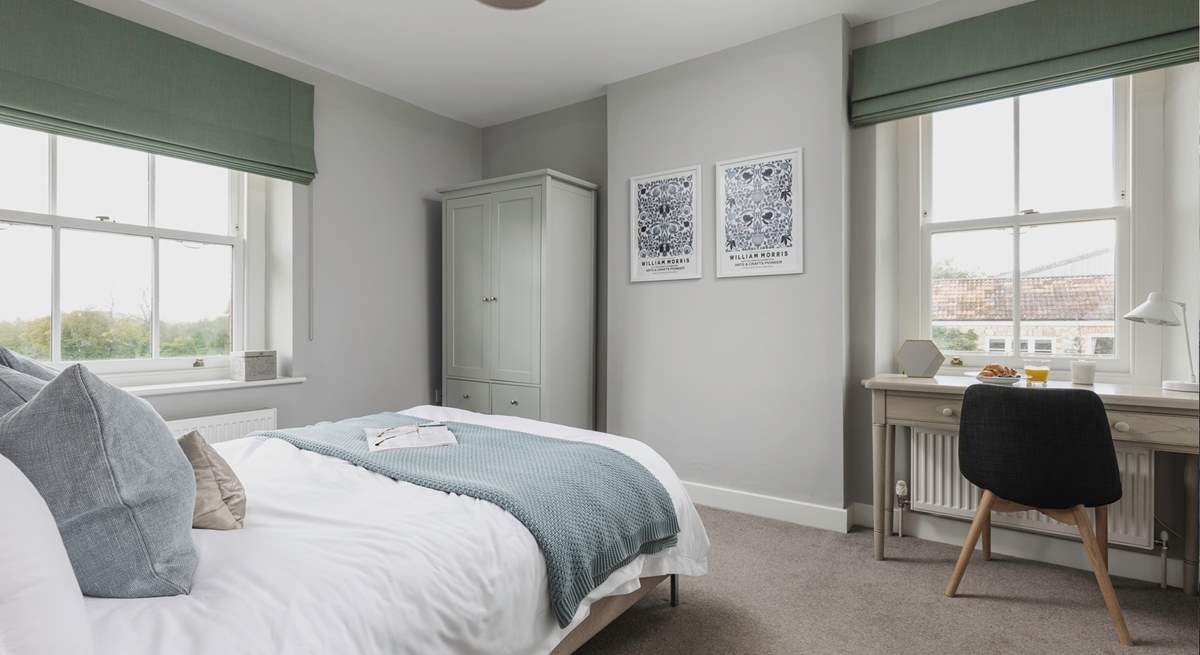 The second window looks over the courtyard and brings extra light into this calm bedroom space.