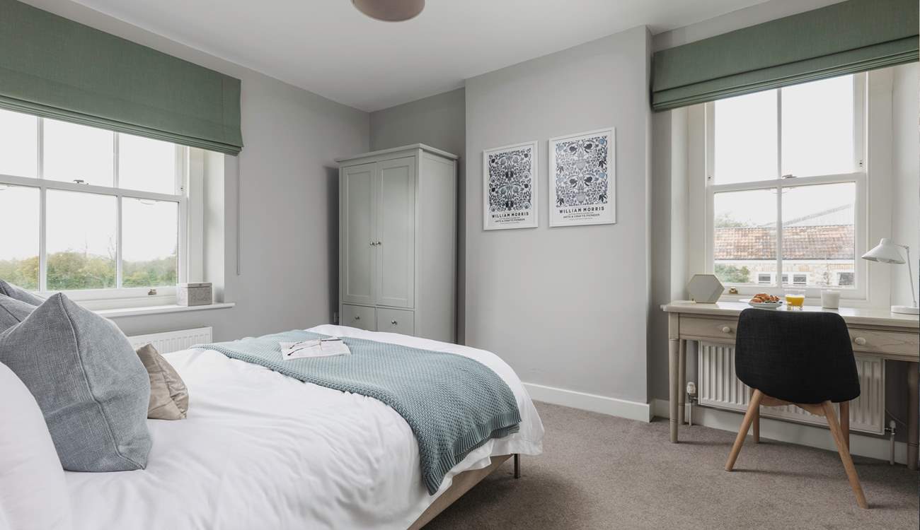 The second window looks over the courtyard and brings extra light into this calm bedroom space.