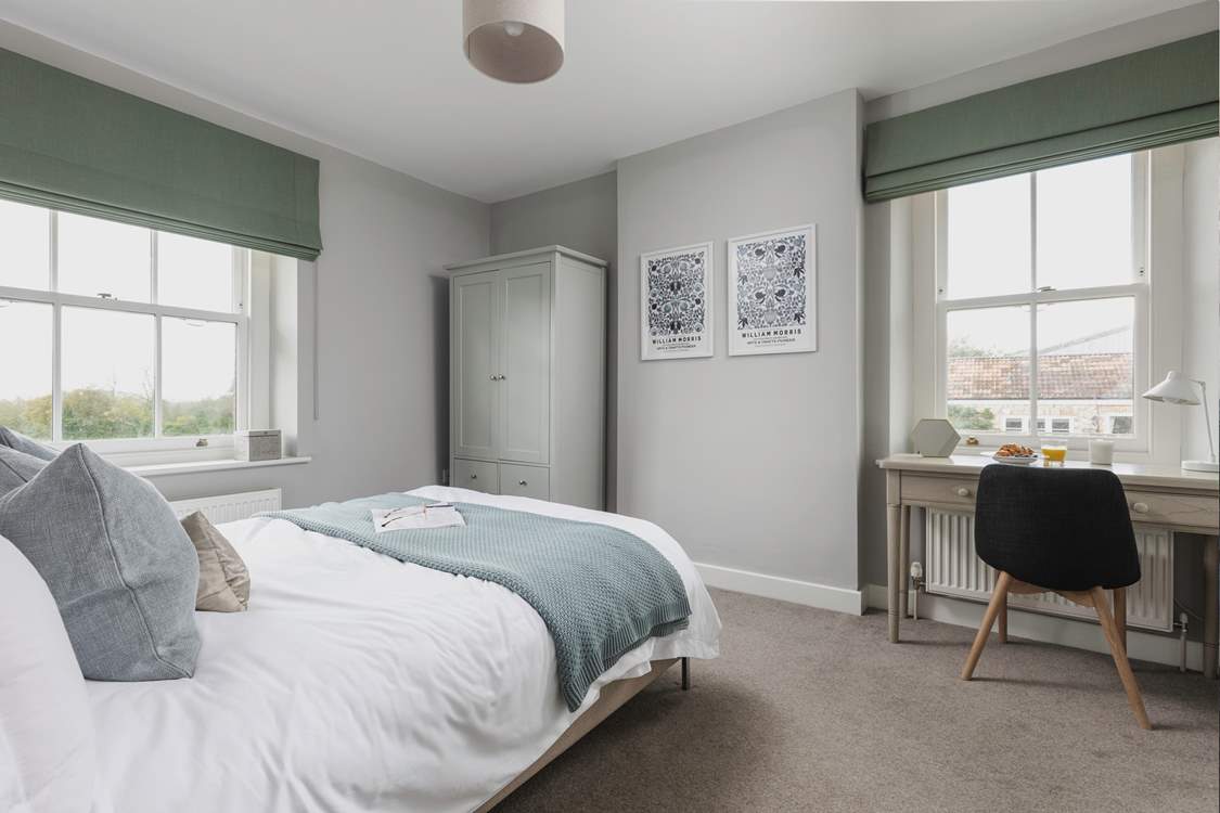 The second window looks over the courtyard and brings extra light into this calm bedroom space.