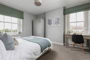 The second window looks over the courtyard and brings extra light into this calm bedroom space.
