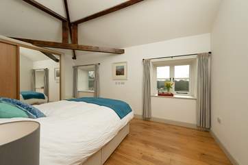 This is one of the two spacious double bedrooms. This bedroom looks out over the farmhouse garden and to the valley beyond. A privacy fence separates the two properties.