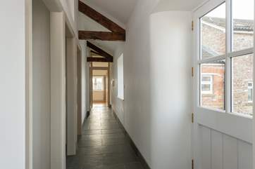 A wide corridor leads to the bedrooms. You can glimpse Wreath Farmhouse (4445) through the front door of the cottage.