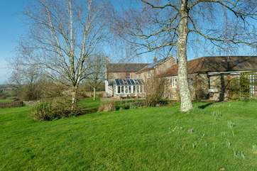 The Stables is the single-storey cottage in the foreground. Wreath Farmhouse (4445) is beyond it. The private cottage garden is behind the trellis fencing.