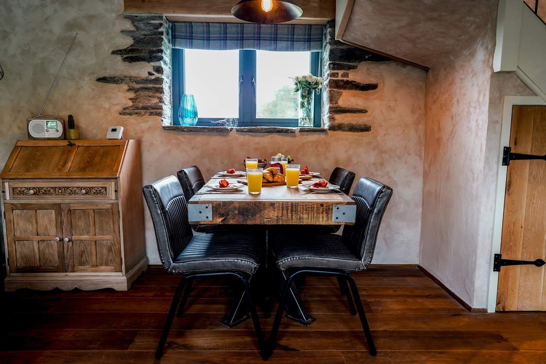 A perfectly positioned dining-table on the ground floor, situated between the kitchen and sitting-area.