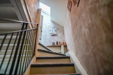 The stairs have fixed stair-gates at both the top and bottom.
