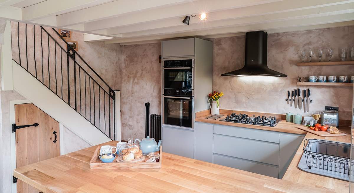 The kitchen also has a handy breakfast-bar with two stools that add to this wonderful open plan space. 