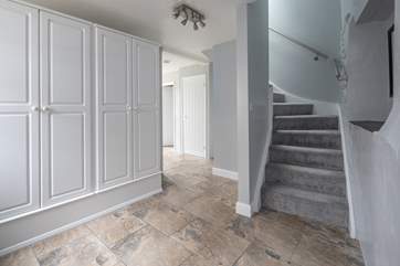 Stairs leading up to the first floor. This ground floor landing offers a wonderful storage space.