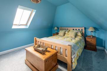 The master bedroom is colourful and airy.