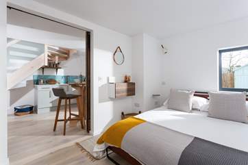 The view from the bedroom to the kitchen and dining areas.