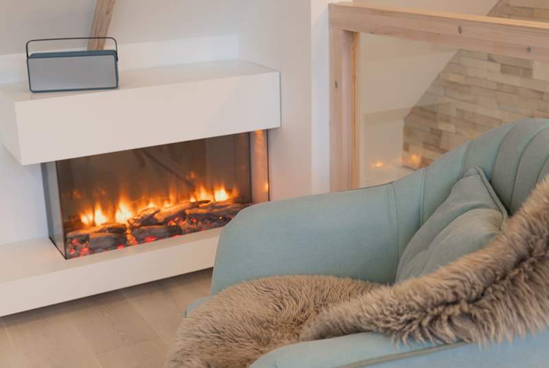 A contemporary fire keeps you warm and cosy.