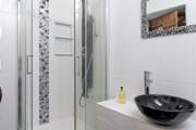 The en suite shower-room for Bedroom 5 has fun decor.