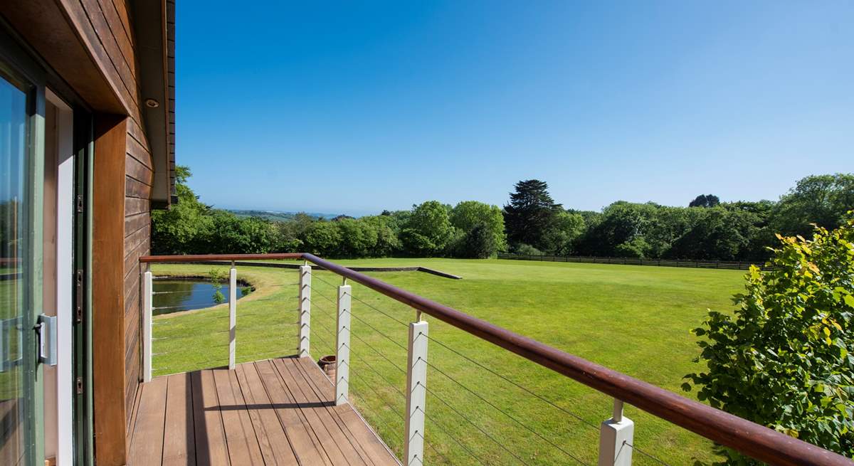 The balcony from the master bedroom overlooks the grounds. 