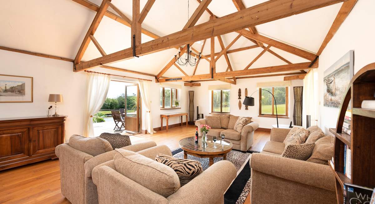 The light and airy sitting-room has double doors that open onto the decking, overlooking the pond.